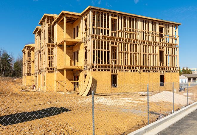 a snapshot of temporary chain link fences protecting a large construction project from unauthorized access in Madison Heights